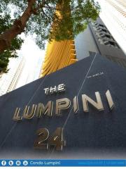 Exterior view of The Lumpini 24 Condo with signage and surrounding trees