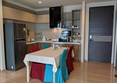 Modern kitchen with dining area, stainless steel appliances, and ample cabinet space