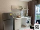 Compact modern kitchen with appliances and brown curtains