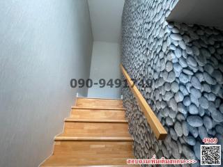 Contemporary wooden staircase with unique stone wall design