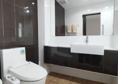 Modern bathroom with wooden floor and elegant fixtures