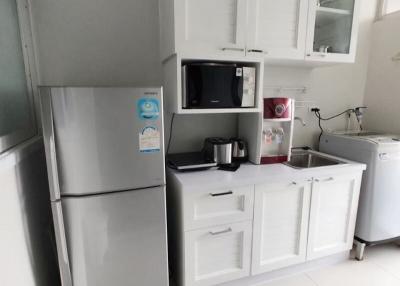 Modern kitchen with white cabinets and stainless steel appliances