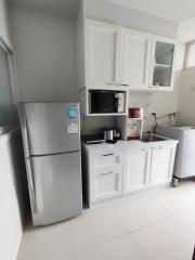 Modern kitchen with white cabinets and stainless steel appliances