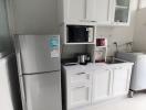 Modern kitchen with white cabinets and stainless steel appliances