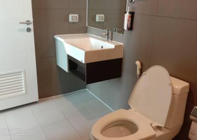 Modern bathroom with wall-mounted sink and toilet