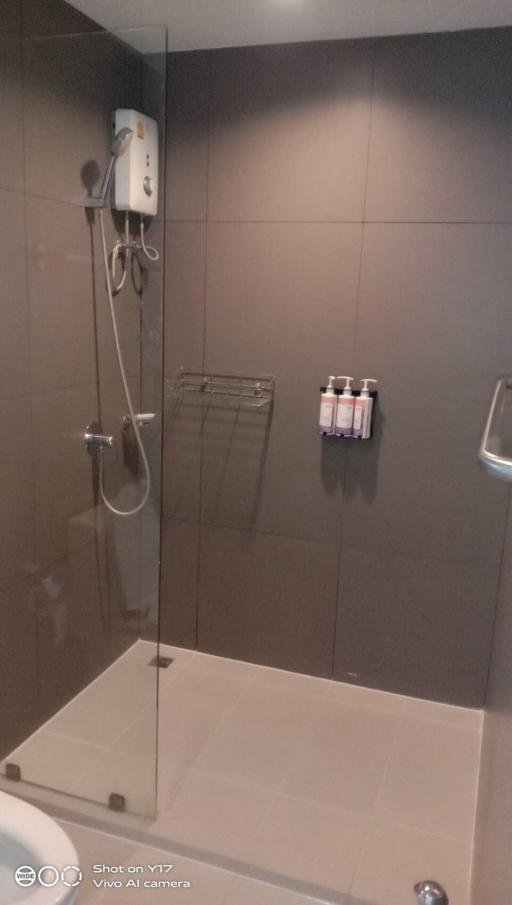 Modern bathroom with glass shower enclosure and wall-mounted heater