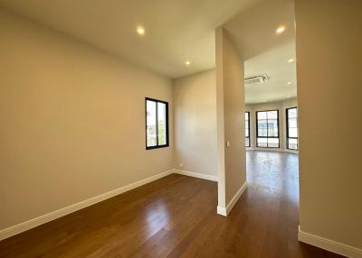 Spacious empty room with hardwood floors and ample natural light