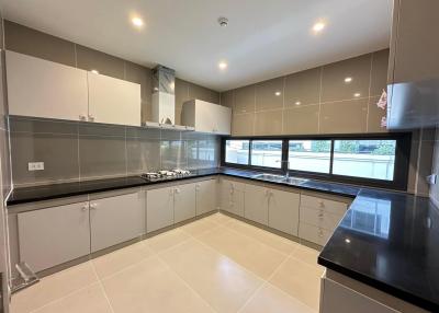 Spacious modern kitchen with ample counter space and natural light