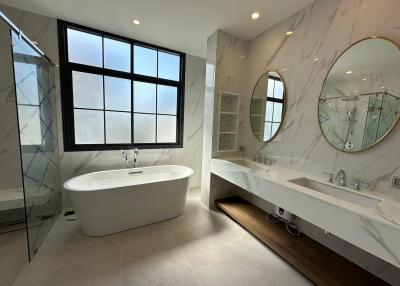 Spacious modern bathroom with a large bathtub and double vanity