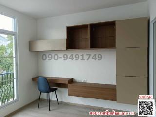 Compact bedroom with built-in desk and shelving units