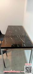 Marble tabletop with QR code and Thai text in an indoor setting