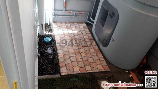 Tiled outdoor area with decorative stones and pet house