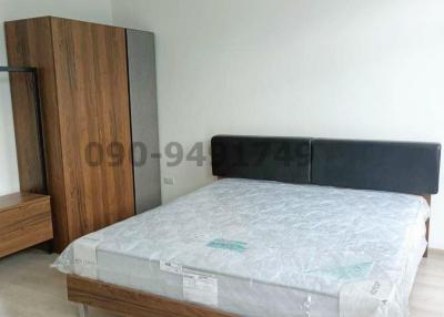 Modern bedroom with a large bed and wooden wardrobe