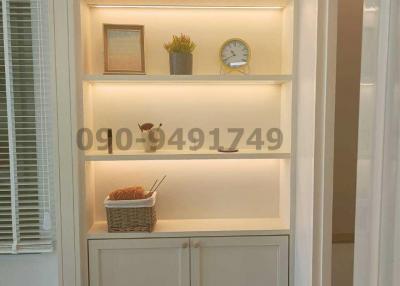 Modern built-in white shelving unit with decorative items