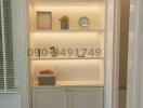 Modern built-in white shelving unit with decorative items