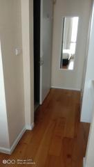 Narrow hallway with wooden flooring in a modern apartment