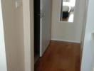 Narrow hallway with wooden flooring in a modern apartment