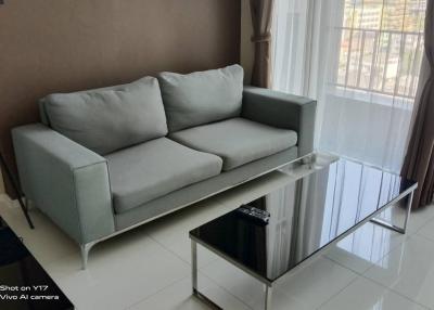 Modern living room with large sofa and glass coffee table