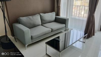 Modern living room with large sofa and glass coffee table