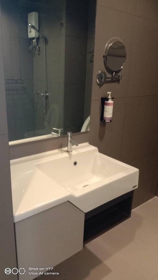 Modern bathroom interior with white sink and wall-mounted mirror