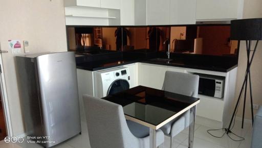 Modern kitchen with integrated appliances and dining area