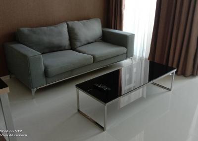 Modern living room with gray sofa and glass coffee table