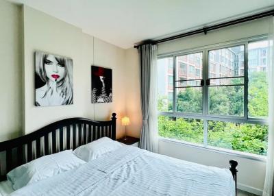 Cozy bedroom with large window and modern wall art