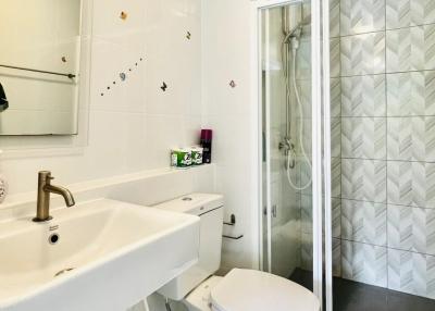 Bright bathroom with a modern glass shower and white fixtures