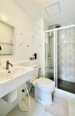 Bright bathroom with a modern glass shower and white fixtures