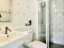 Bright bathroom with a modern glass shower and white fixtures