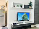 Modern living room with mounted television and decorative shelving
