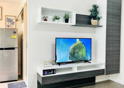 Modern living room with mounted television and decorative shelving
