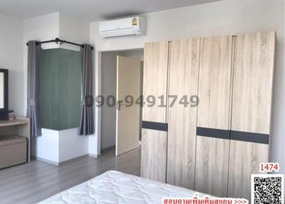 bedroom with large bed, air conditioner, and wardrobe