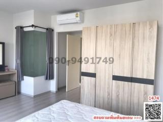 bedroom with large bed, air conditioner, and wardrobe