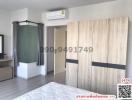 bedroom with large bed, air conditioner, and wardrobe