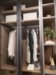 Well-organized closet with clothing and shelves