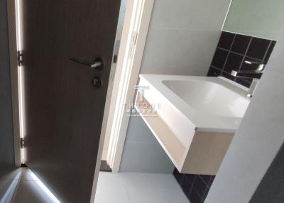 Modern bathroom interior with dark tiles and large sink