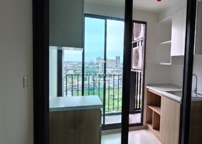 Compact kitchen with modern appliances and city view