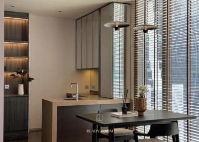 Modern kitchen with clean lines, featuring wooden cabinetry, stone countertops and a dining area