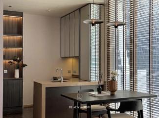 Modern kitchen with clean lines, featuring wooden cabinetry, stone countertops and a dining area