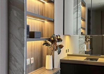 Modern kitchen with wooden open shelving, sleek surfaces, and mirrored backsplash