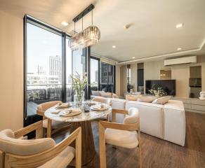 Modern living room with dining area and city view