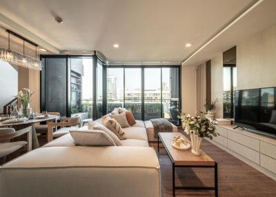 Spacious modern living room with ample natural light and balcony access