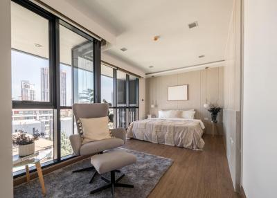 Bright and spacious bedroom with large windows and city view