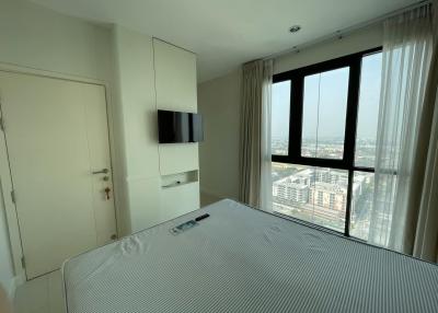 Spacious bedroom with large windows and city view