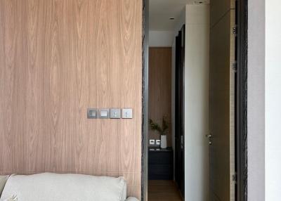 Modern entryway with wooden wall paneling and elegant door