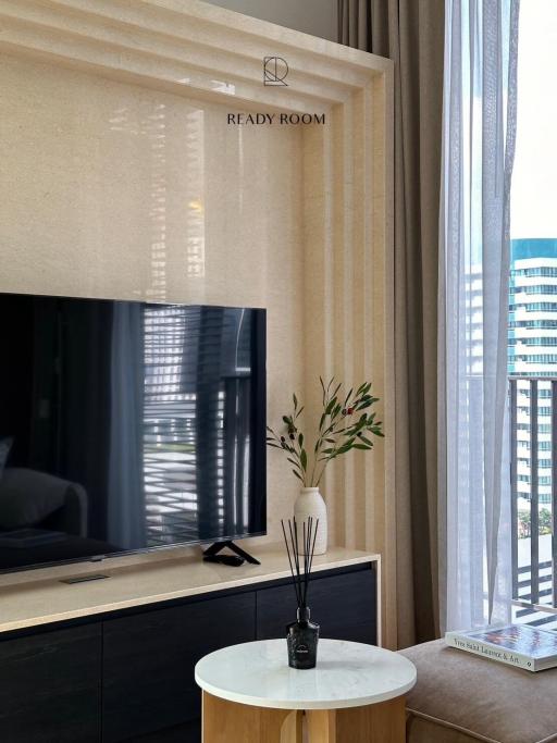 Modern living room interior with large window, television, and decorative elements