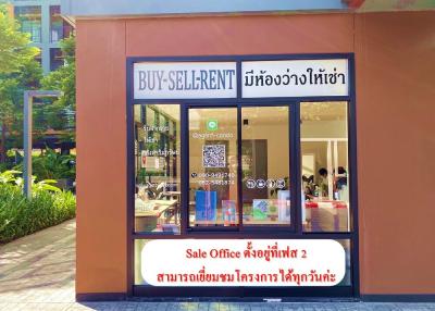 Exterior view of a real estate office with large windows and marketing signs