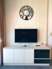 Modern living room with wall-mounted television and wooden backdrop