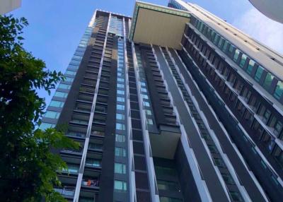 Modern high-rise residential building with clear blue sky